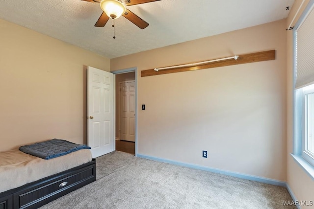 unfurnished bedroom with carpet, baseboards, and ceiling fan