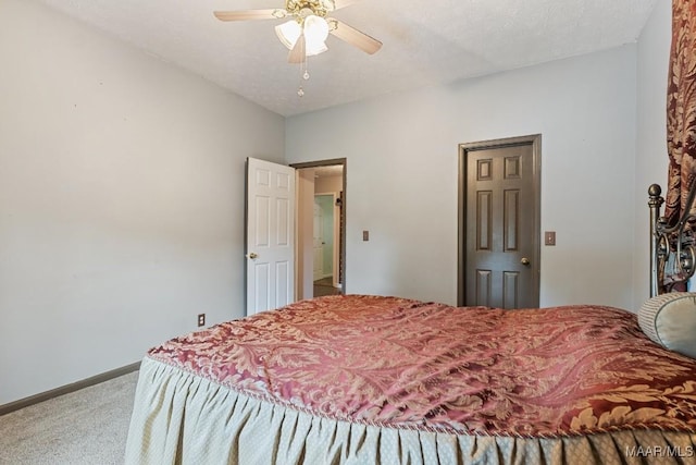 bedroom with carpet flooring, baseboards, and a ceiling fan