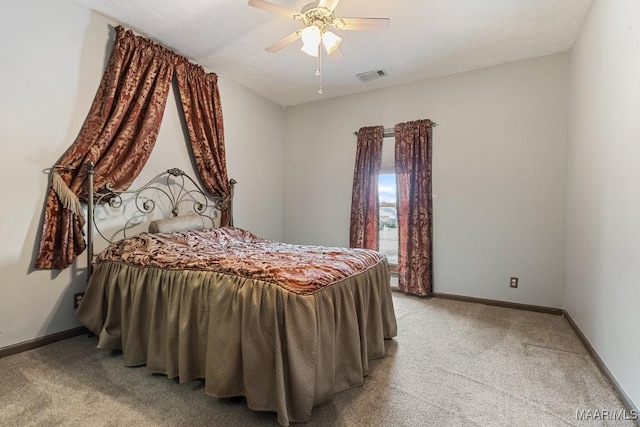 bedroom with light colored carpet, baseboards, and a ceiling fan