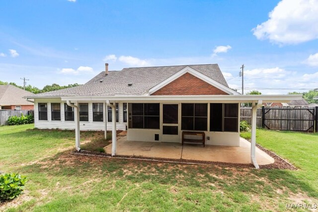 rear view of house featuring a sunroom, a patio area, and roof with shingles