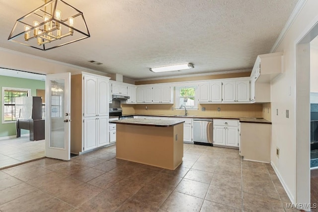 kitchen with appliances with stainless steel finishes, crown molding, under cabinet range hood, white cabinetry, and a sink