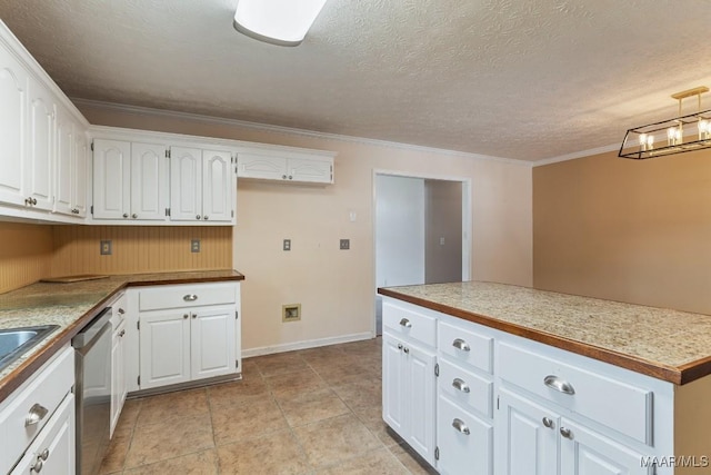 kitchen with stainless steel dishwasher, white cabinets, ornamental molding, a textured ceiling, and baseboards