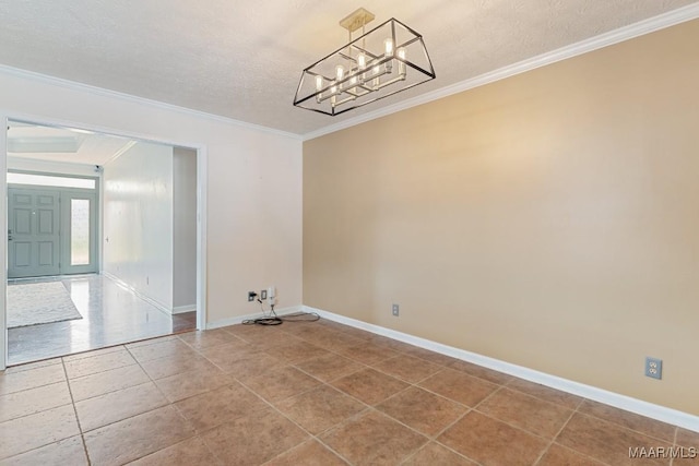 empty room with a chandelier, baseboards, ornamental molding, tile patterned floors, and a textured ceiling