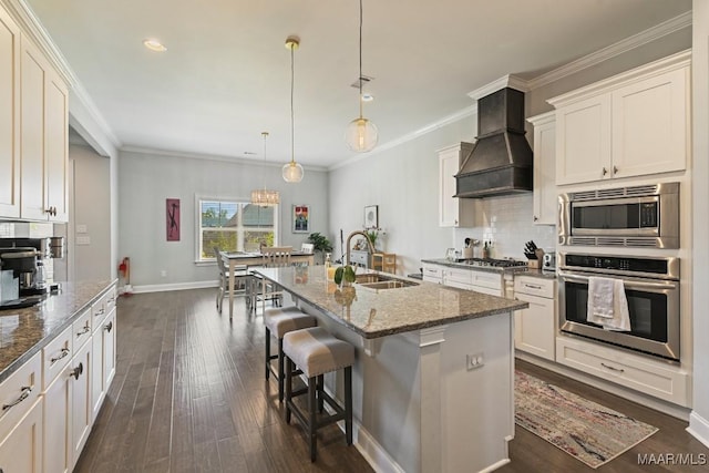 184 Houston St, Prattville, AL 36066 - kitchen featuring a sink, dark stone countertops, custom range hood, dark wood-type flooring, and appliances with stainless steel finishes