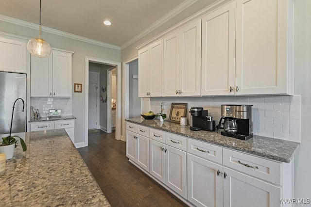 184 Houston St, Prattville, AL 36066 - kitchen with white cabinets, backsplash, dark stone counters, stainless steel fridge, and dark wood-style flooring