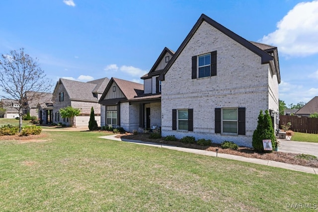 184 Houston St, Prattville, AL 36066 - view of front of home featuring a front lawn, brick siding, and fence