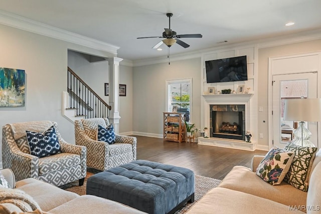 184 Houston St, Prattville, AL 36066 - living area featuring crown molding, wood finished floors, ceiling fan, a tiled fireplace, and ornate columns