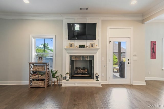 184 Houston St, Prattville, AL 36066 - living room featuring a tiled fireplace, a healthy amount of sunlight, wood finished floors, and ornamental molding