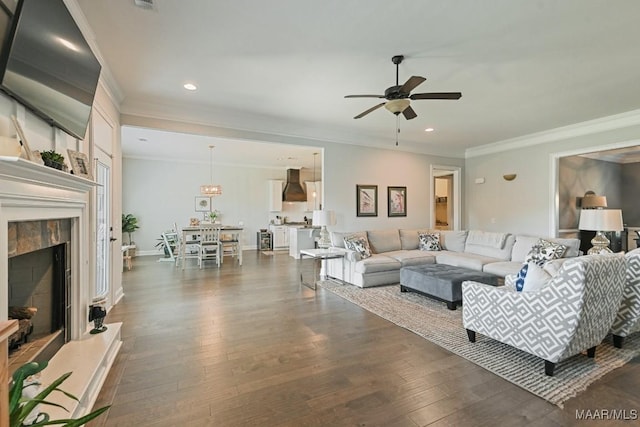 184 Houston St, Prattville, AL 36066 - living room with a ceiling fan, a fireplace, ornamental molding, dark wood-style floors, and recessed lighting