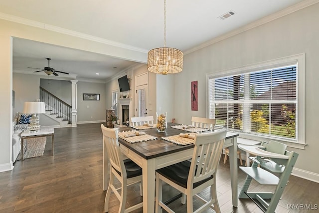 184 Houston St, Prattville, AL 36066 - dining space featuring baseboards, stairs, a fireplace, dark wood-type flooring, and ornamental molding