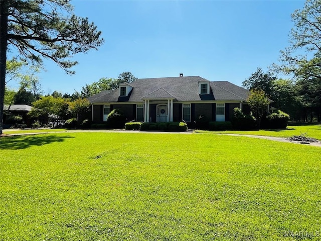 view of front of property with roof with shingles and a front yard