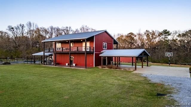 rear view of house with a carport, a lawn, and driveway