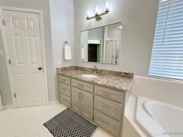 full bath with a bath, vanity, tile patterned flooring, and a shower stall