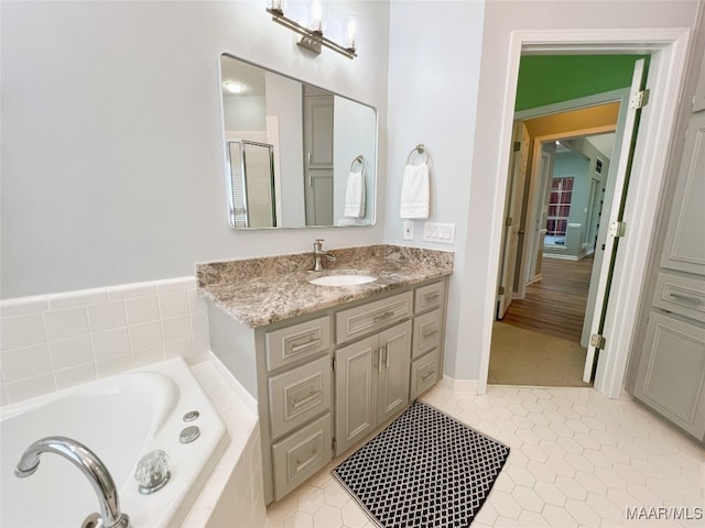 full bathroom with a bath, vanity, tile patterned flooring, and an enclosed shower