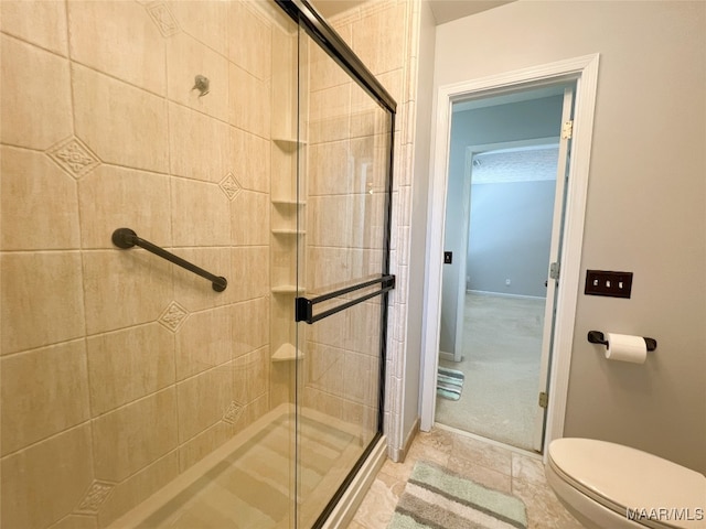 bathroom with toilet and a stall shower