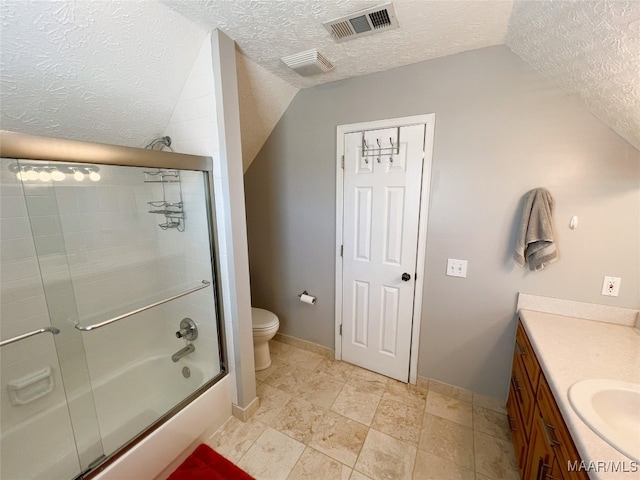 bathroom with a textured ceiling, vaulted ceiling, and visible vents