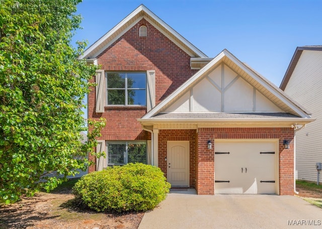 view of front of home with brick siding, an attached garage, and concrete driveway