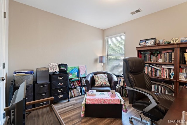 home office featuring wood finished floors and visible vents