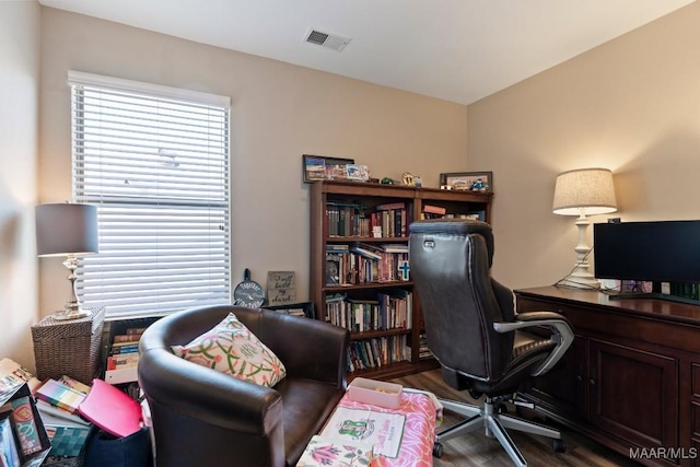 office area with wood finished floors and visible vents