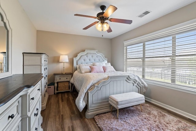 bedroom featuring dark wood finished floors, ceiling fan, multiple windows, and visible vents