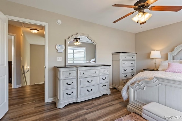 bedroom with attic access, baseboards, dark wood-type flooring, and ceiling fan