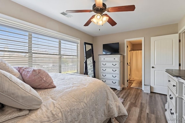 bedroom with visible vents, dark wood-style floors, and ceiling fan