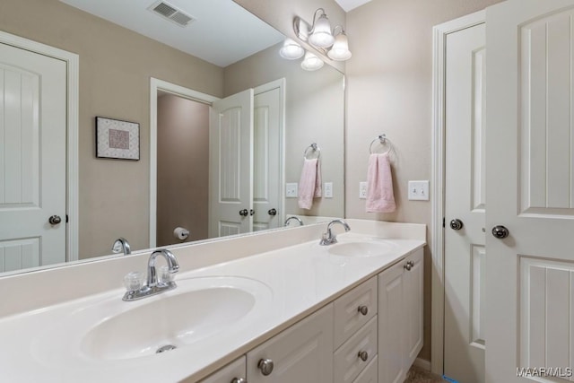 full bathroom featuring a sink, visible vents, and double vanity