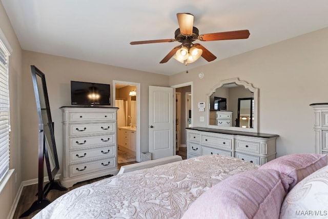 bedroom featuring baseboards, wood finished floors, connected bathroom, and ceiling fan
