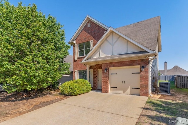 view of front facade with cooling unit, concrete driveway, fence, brick siding, and an attached garage