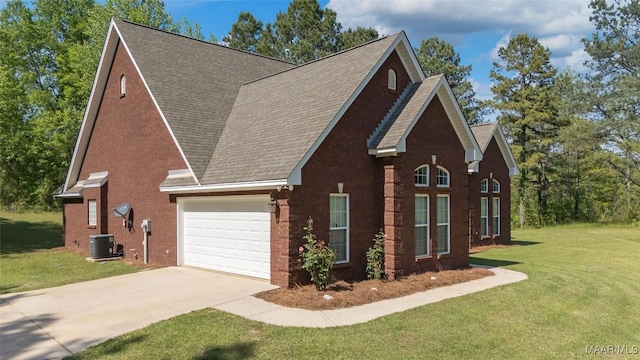 view of front of house featuring a front lawn, driveway, brick siding, and a garage