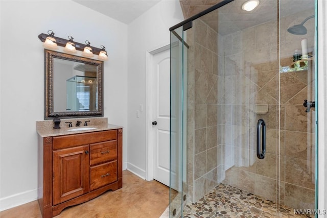 full bathroom featuring baseboards, vanity, and a stall shower