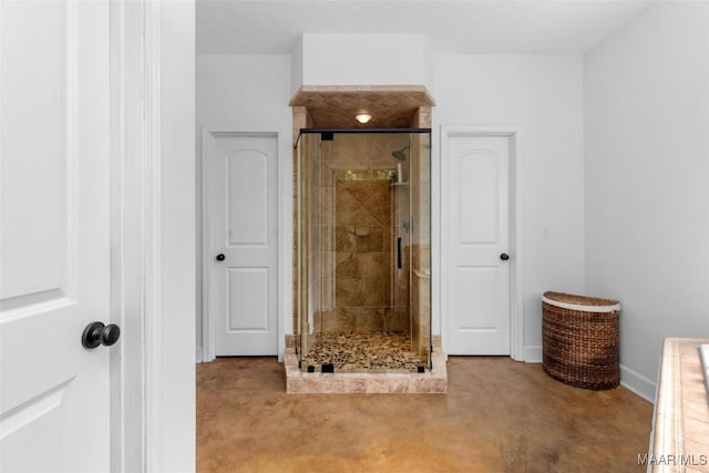 full bathroom featuring baseboards and a stall shower