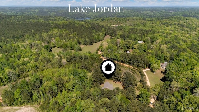 drone / aerial view featuring a forest view