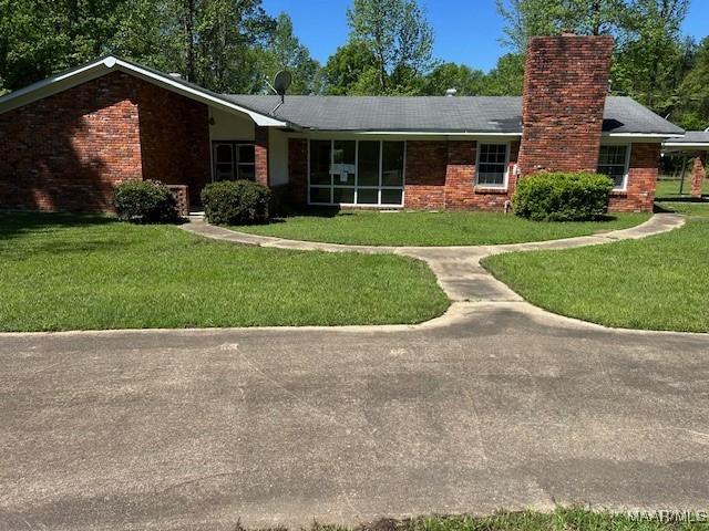 2075 County Road 27, Selma, AL 36701 - view of front facade with a front lawn, brick siding, and a chimney