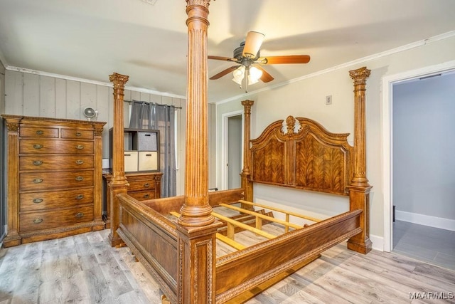 bedroom with ornamental molding, light wood-style flooring, and baseboards