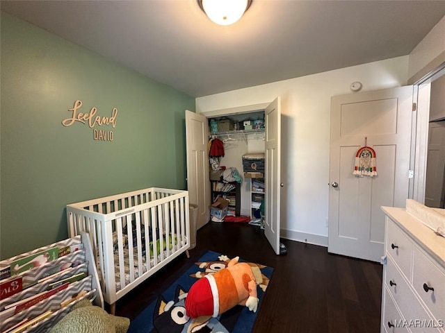 bedroom featuring dark wood-style floors and a closet