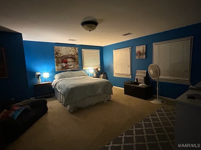 carpeted bedroom featuring visible vents