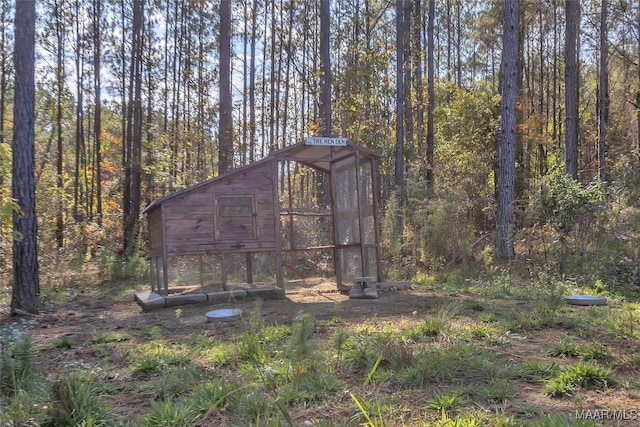 view of poultry coop featuring a wooded view