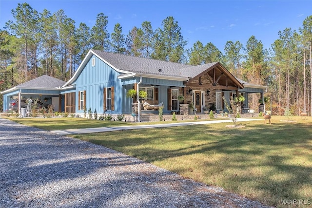 view of front of property featuring a front yard, board and batten siding, and covered porch