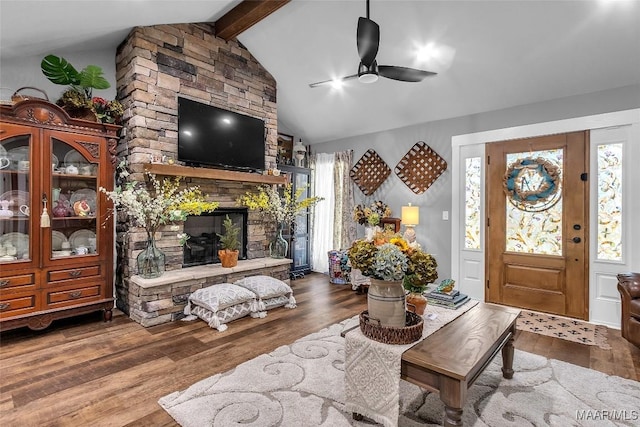 interior space featuring wood finished floors, a healthy amount of sunlight, vaulted ceiling with beams, and ceiling fan