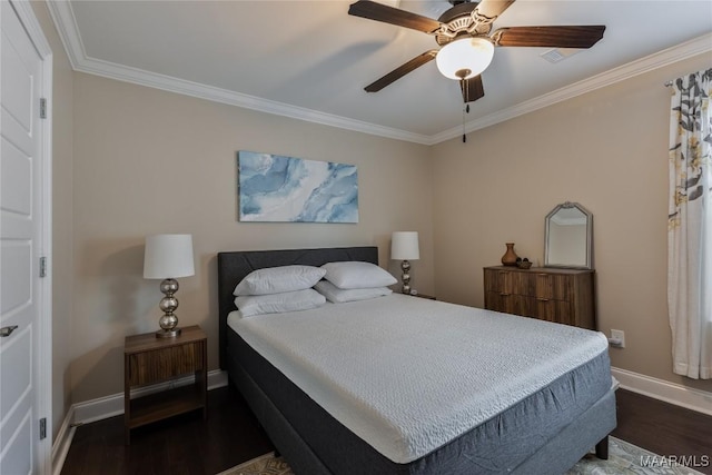 bedroom with baseboards, wood finished floors, and crown molding