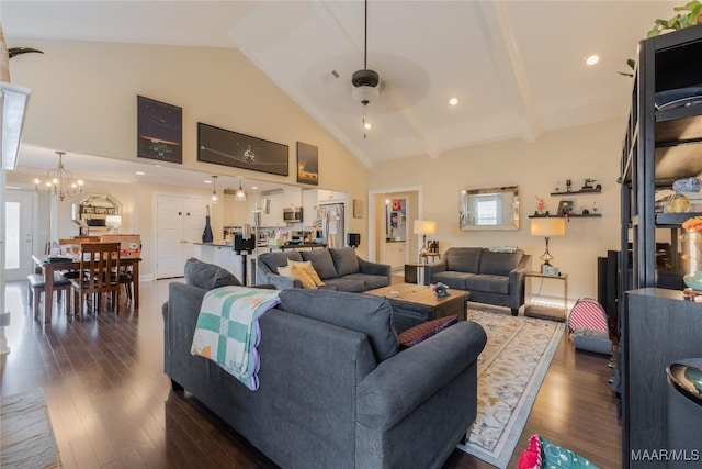 living area featuring ceiling fan with notable chandelier, high vaulted ceiling, and dark wood finished floors