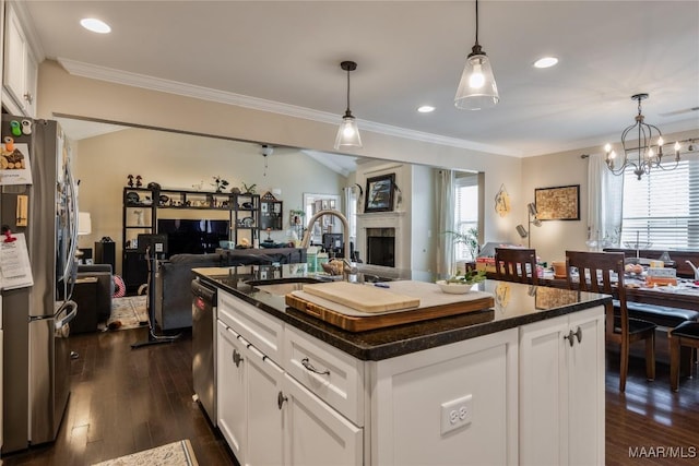 kitchen with a wealth of natural light, open floor plan, stainless steel appliances, and a sink
