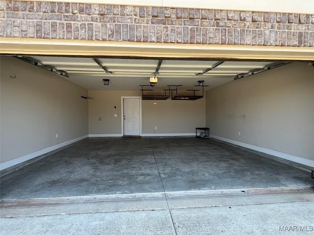 garage with baseboards and a garage door opener