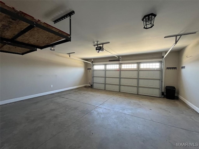 garage with baseboards and a garage door opener