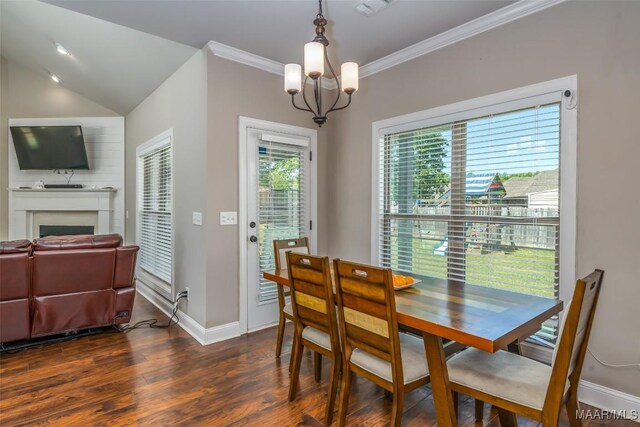 1017 Ridge Point Dr, Deatsville, AL 36022 - dining space with dark wood-style floors, baseboards, a chandelier, a fireplace, and ornamental molding