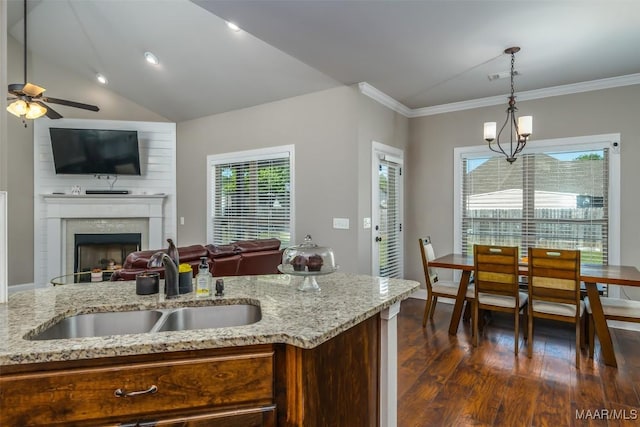 1017 Ridge Point Dr, Deatsville, AL 36022 - kitchen with crown molding, a sink, ceiling fan, a fireplace, and dark wood finished floors