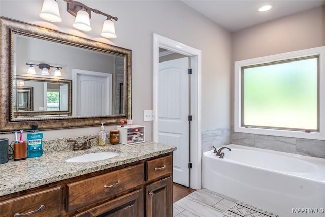 1017 Ridge Point Dr, Deatsville, AL 36022 - bathroom with plenty of natural light, a garden tub, vanity, and recessed lighting