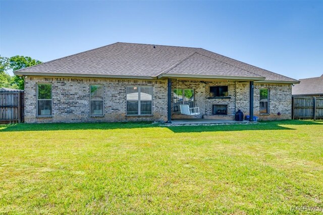 1017 Ridge Point Dr, Deatsville, AL 36022 - rear view of property with brick siding, fence private yard, a patio area, and a fireplace