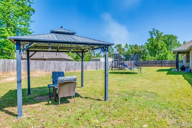 1017 Ridge Point Dr, Deatsville, AL 36022 - view of yard featuring a fenced backyard, a gazebo, and a trampoline